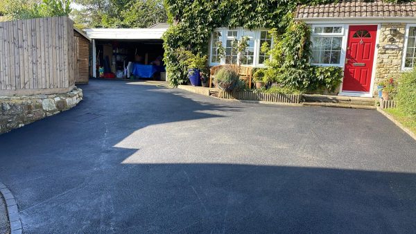 Tarmac with edging kerb border in Bourton-on-the-Water